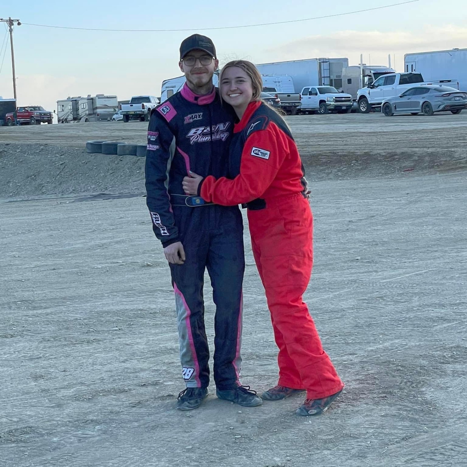 Cody and Aspen Blixt in racing suits at the dirt track