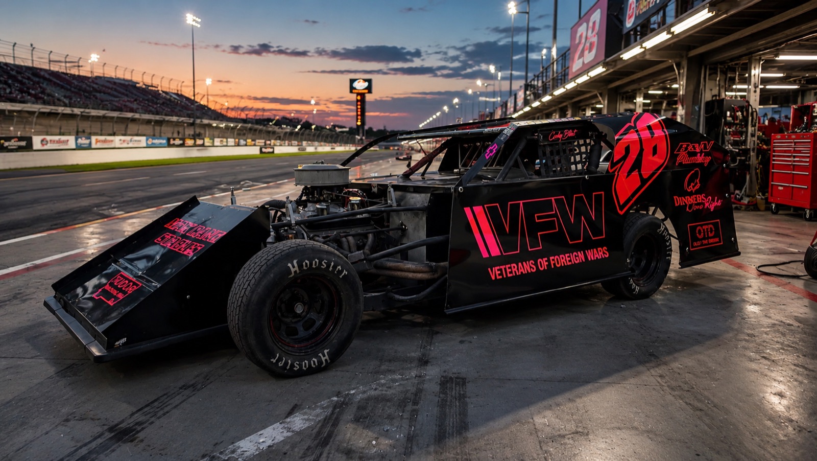 Custom wrapped dirt track race car at night in the pits, Utah